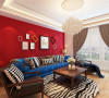 沙发背景墙大面积运用红色，让空间的中间部分靓丽起来，搭配了蓝色的绒布材质的沙发，质感十足，配以深木色的茶几、配椅，让空间沉稳下来