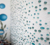 卧室墙面的独特处理却是简单且美化空间，卧室淡淡的蓝色玻璃球使整个白色的墙面变得更亮丽