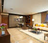 客厅的家具采用了现代感的沙发与传统的木质感相结合的家具这样把新中式的与现在流行的家具结合在一起。客厅与餐厅的背景墙用深色的软包，这样的设计既体现出客厅的时尚。