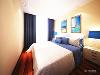 卧室的设计也是沿用了整体空间的三大色调，蓝白色的床上用品，蓝白色的窗帘，以及浅黄色的墙面处理。整个空间的面积较小，所以造型方面都很简洁，色调明确。