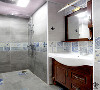 灰色的水泥砖上下分隔，简约素雅。下方的浴室柜增添了一丝复古气息。