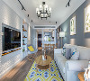 墙壁大面积的蓝灰色配上白色的布艺沙发，与对面的白色文化石电视背景墙相互呼应，再点缀上清新亮眼的黄色，既展现了时尚品味也让室内格局有层次变化感。