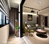 林峰安设计师于玄关廊道及客厅之间，透过深色门框设计与异质地坪的划分，让内外的机能设定更明晰。
