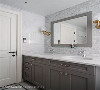 主卧卫浴同样以线板元素打造柜体，不同的是多了更多亮面磁砖，使其容易清扫打理，也为恬淡的居家挹注低调的华丽。